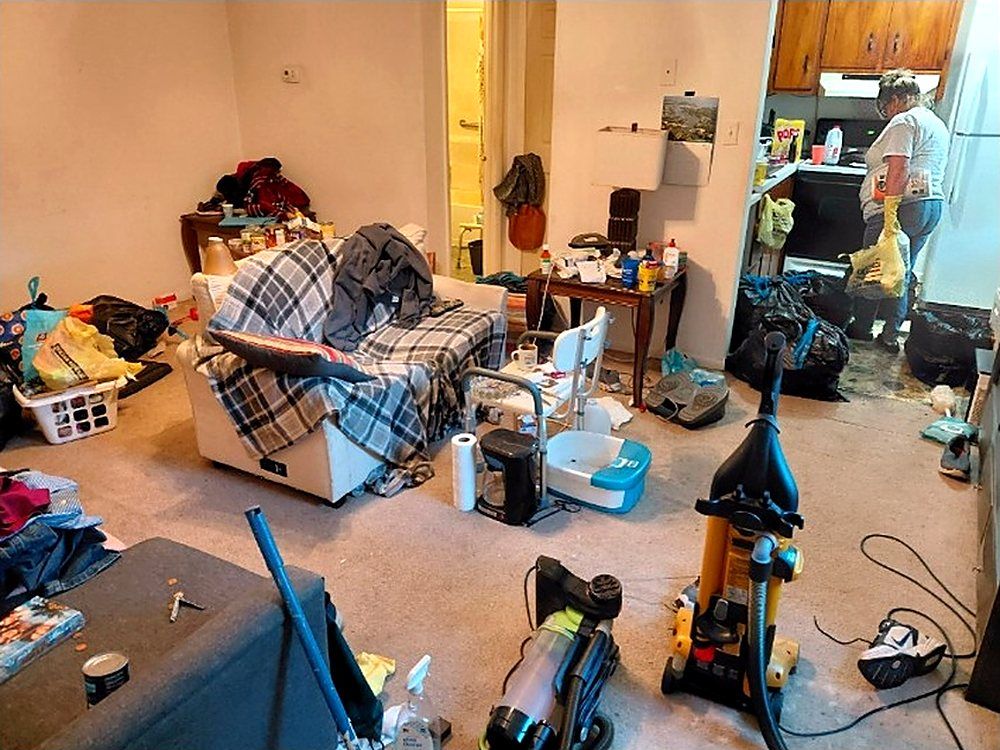Cluttered living room before service